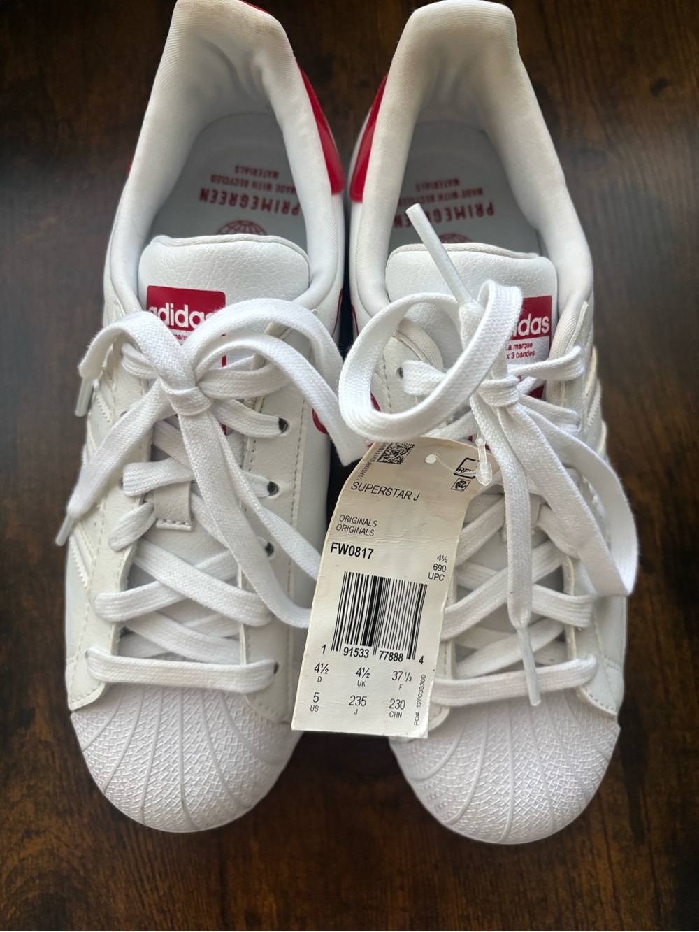 Adidas white sneakers with red accents